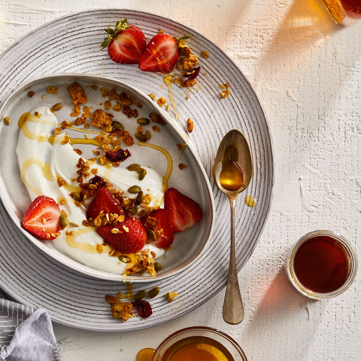 Raw and gently filtered honey drizzled on yogurt